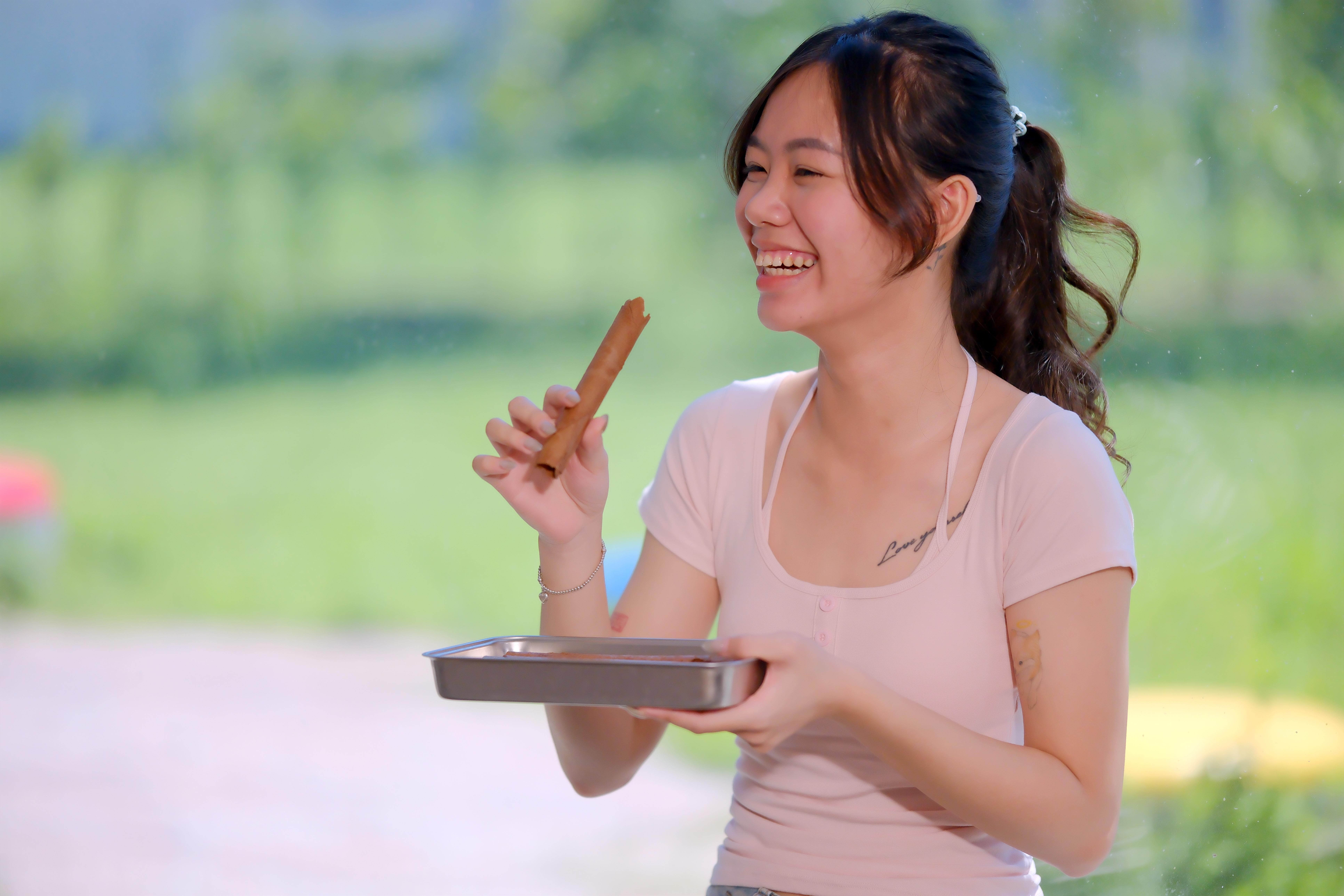 吃著自製的可可蛋捲，開心得合不攏嘴。